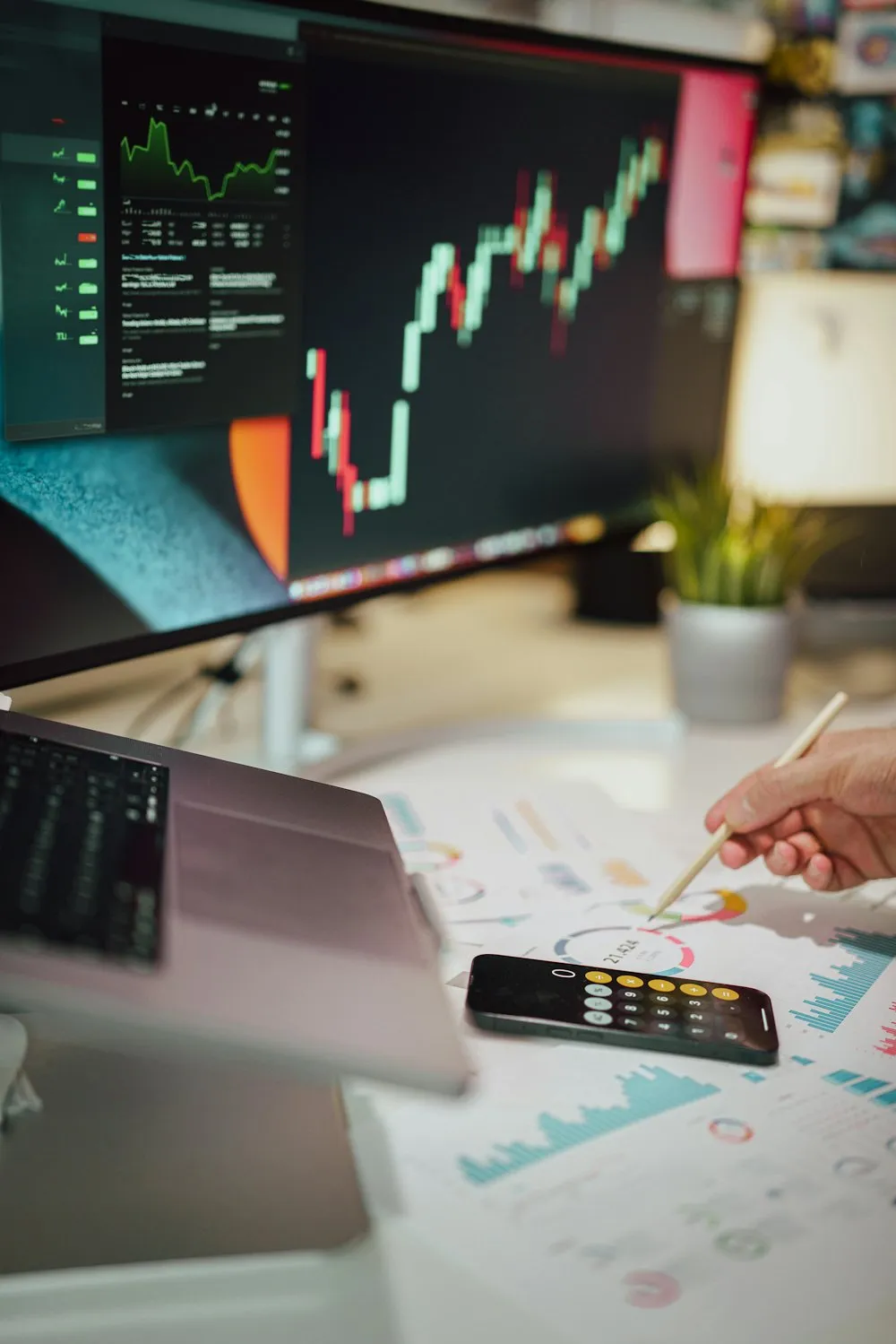 Monitor displaying financial charts on a desk