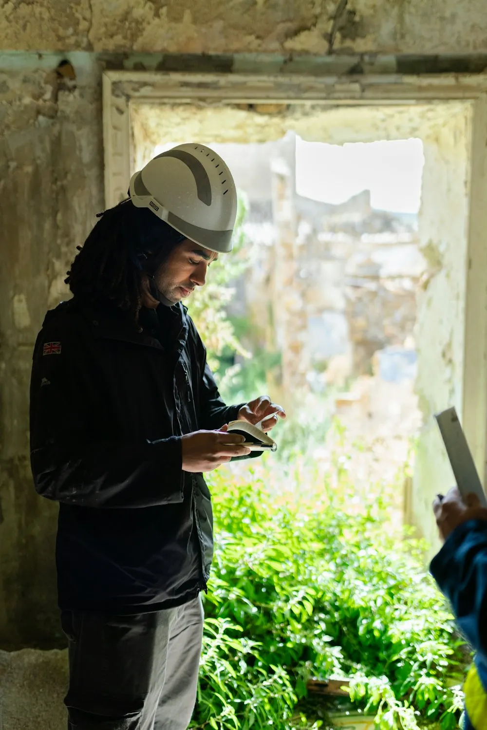 Person outdoors entering details on a handheld tablet